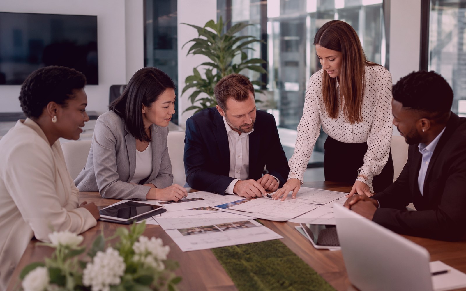 Professional people discussing event space requirements